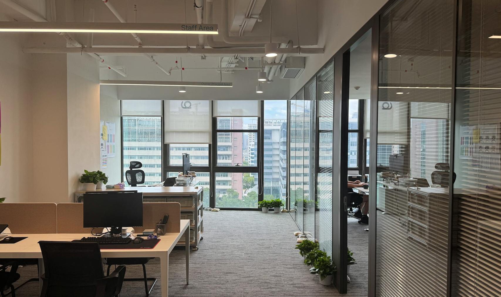 Bright, modern office interior with large windows and open workspace design.